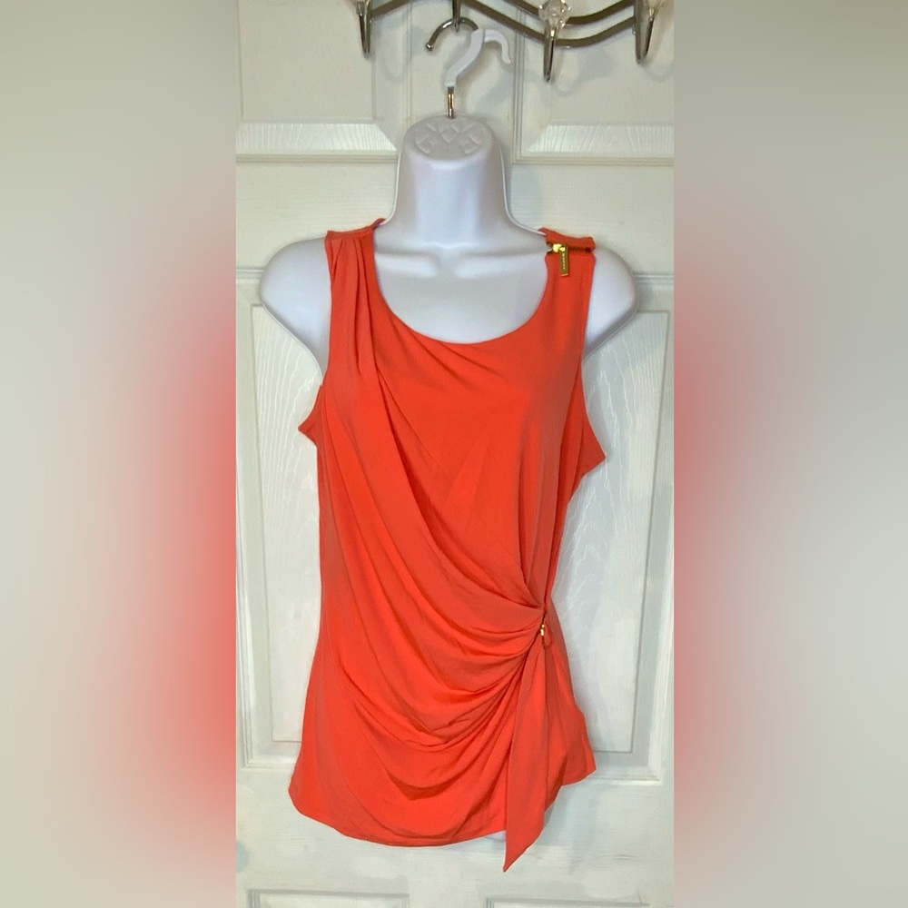 Michael Kors blouse design with his signature embossed gold zipper and buckle.